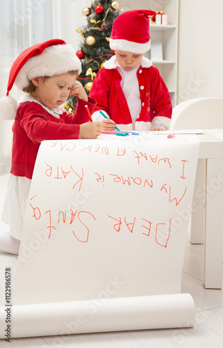Obraz na płótnie little kids in Santa hat writing letter to Santat under the Christmas tree w salonie
