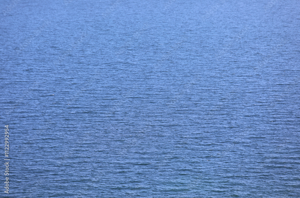 Obraz premium background with the placid saltwater of a calm blue sea without boats, ideal as a marine or nature backdrop