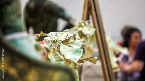 Photography banknotes hang in the open air in a temple in bangkok