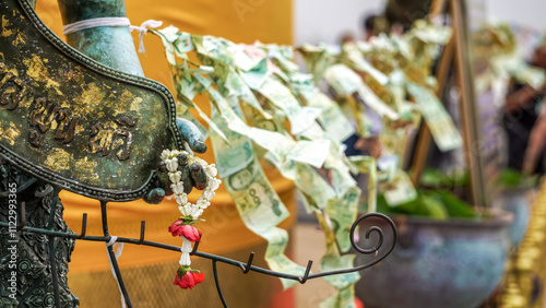 Photography banknotes hang in the open air in a temple in bangkok