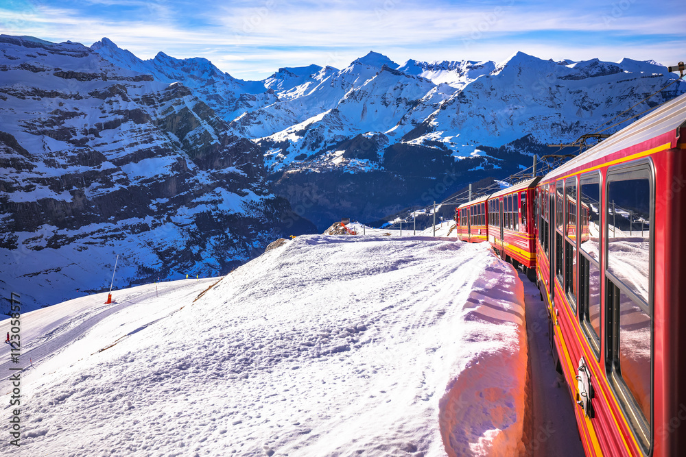 Alps train descending down from Jungfraujoch peak to Wengen, idyllic alpine landscape