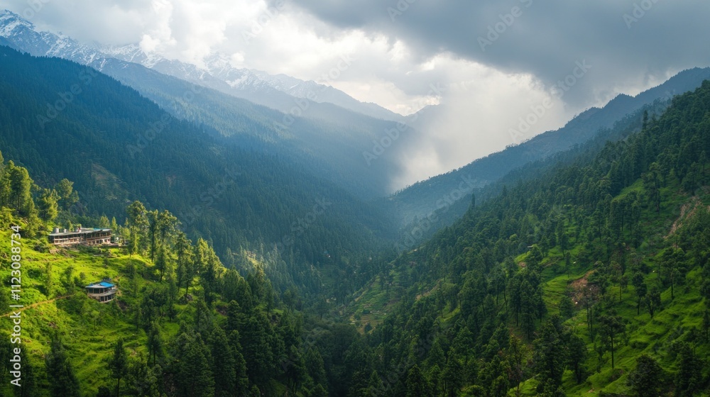 Fototapeta premium A breathtaking view of a lush green valley surrounded by mountains, under a dramatic sky filled with clouds.