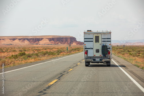 Camper Van, RV, on a US-American Highway  surrounded by Desert an Mountains, Landscape, Copy Space © christianthiel.net