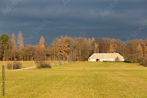 A countryside house at the edge of a field on an autumn evening.