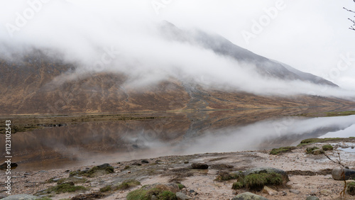 Tourists taking pictures of loch achtriochtan and buachaille etive mor in glencoe, scotland photo