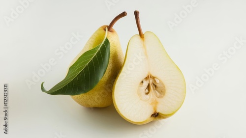 Pear and Leaf with a Cut Half Over White photo