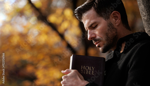 Принти на полотні Christian tightly hug and pray with holy bible in autumn with Holy light shining