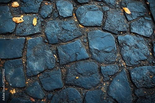 asphalt surface showcasing a textured grungy appearance with dark grey tones and subtle graininess captured from above emphasizing the ruggedness of the road below