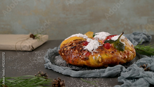 Bolo Rei or Kings Cake is a traditional Xmas cake with fruits raisins nut and icing on kitcthen countertop. Is made for Christmas, Carnavale or Mardi Gras photo