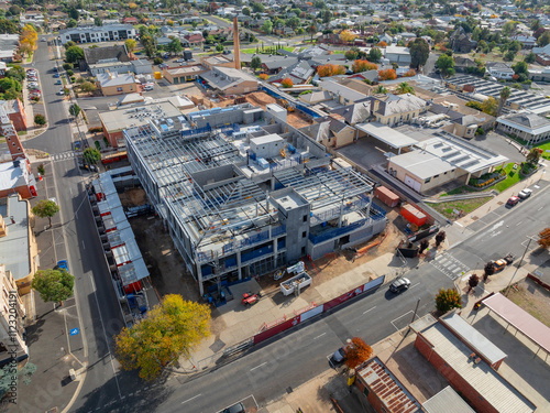 Aerial view of multi level construction site alongside existing city buildings photo