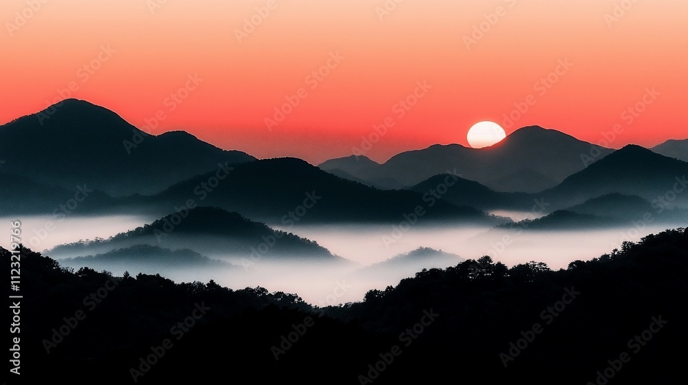 Obraz premium Sunrise over misty mountain range.