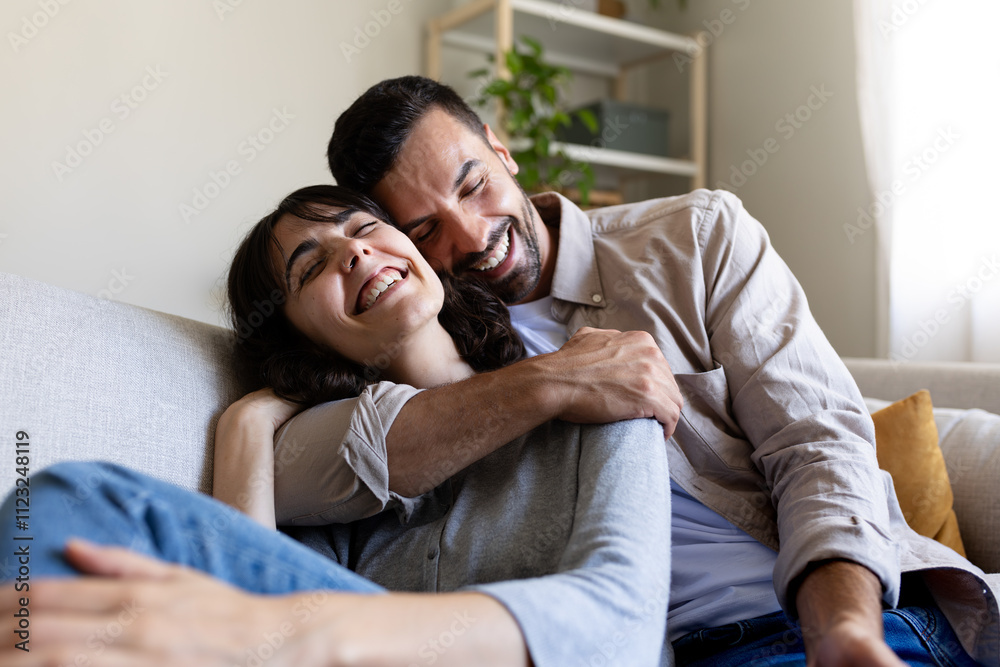 Affectionate happy couple in love hugging, relaxing on the couch. Affectionate happy couple in love hugging, relaxing on the couch.