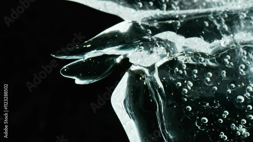 Timelapse of ice melting, with the sun shining through the crystals