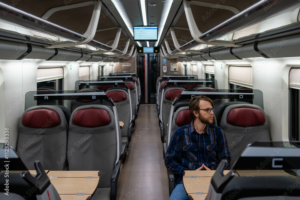 Fototapeta premium Passenger Traveling Alone in a Modern Train
