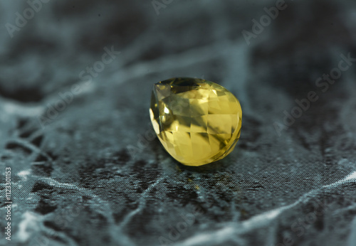 golden yellow citrine gemstone, on a black-white backgrond black-white marble