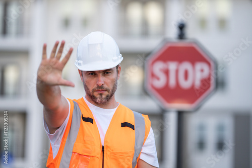 Construction worker with stop sign. stop sign or paddle used for traffic control by crossing guards, police or work zones. Construction area warning sign, stop hand safety