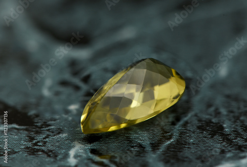 golden yellow citrine gemstone, on a black-white backgrond black-white marble
