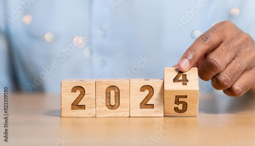 New project growth concept in 2025, Preparation for happy new year , Hand of man flip wooden