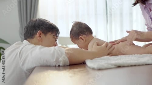 Asian baby and families who have to work while raising children at home