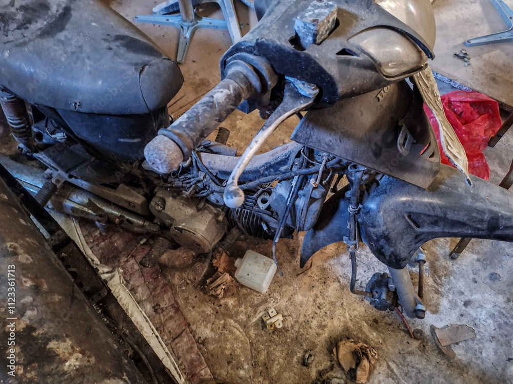 Obraz premium Photo of old and broken motorcycle in garage. Selective focus. 