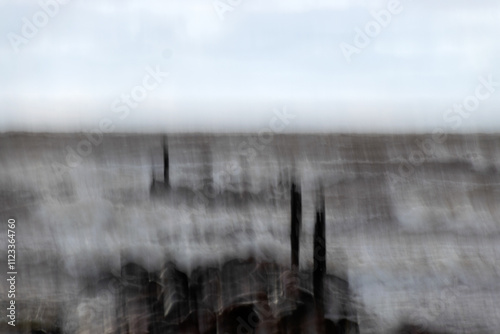 Fototapeta Naklejka Na Ścianę i Meble -  dramatic storm in the Baltic Sea, large waves crashing against the stone pier, blurred, unclear contours, rocky shore of Vidzeme