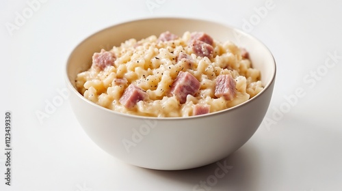 Close-Up of Creamy Ham Risotto in an Off-White Bowl on a Minimalist Surface