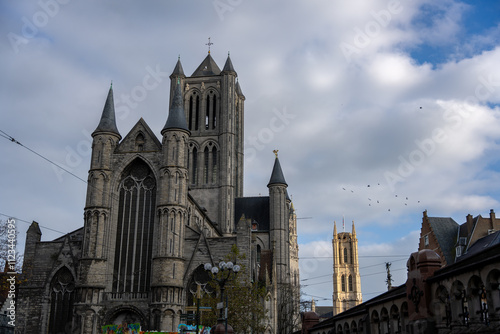 Saint Nicholas Church. Ghent, Flemish Region, Belgium. At the back, Saint Bavo’s cathedral Ghent. photo