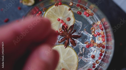 Prepare a cocktail with soda, lemon and Sichuan pepper, ice cubes on top