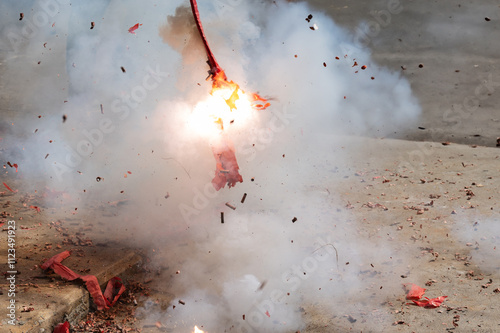 Red firecrackers exploding in the street for the chinese new year celebration day.Chinese New Year festival firecrackers with smoke. photo