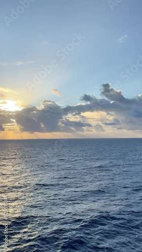 Watching sunset on the sea from deck of a cruise ship with a beautiful sky above 