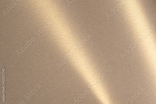 Luxurious paper background with a soft monochrome gradient in warm taupe and champagne tones. Smooth