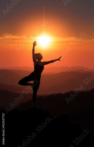 Wallpaper Mural woman performs a yoga pose at sunset on a mountain ridge, surrounded by stunning landscape hues of orange and purple. silhouette against the vibrant sky captures tranquility Torontodigital.ca
