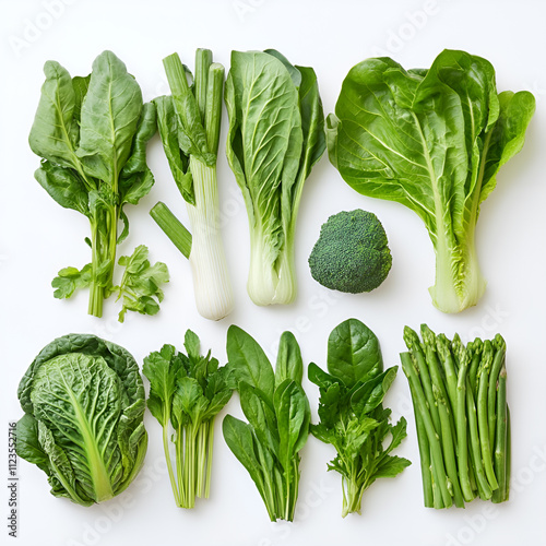 Set of greens on a white background. Lettuce leaves, arugula, Chinese cabbage, asparagus and other green products. Concept of veganism and healthy eating.