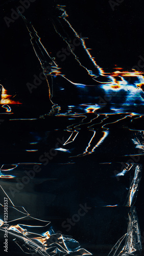 Glitch overlay. Creased film texture. Blue orange white color light flares artifacts dust scratch distressed uneven wrinkled foil defect dark illustration art abstract background.