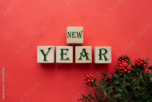 Text NEW YEAR written on wooden cube blocks on red background. Preparation new year  photo