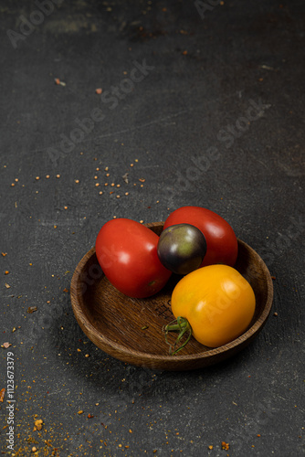 Fresh vegetables with abrasions and defects on a dark table