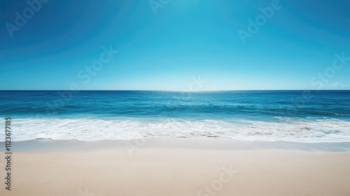 Sandy beach meets deep blue ocean horizon photo