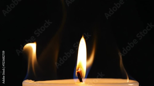 Two glowing candles in the dark, creating a warm and peaceful ambiance, symbolizing hope, remembrance, and quiet reflection. photo