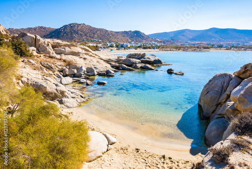 Beautiful sandy beach of Mikri Vigla with rocks in azure sea water, Naxos island, Cyclades, Greece photo