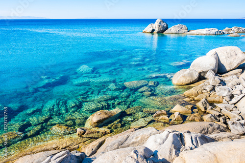 Beautiful coast with rocks in sea near beach of Mikri Vigla, Naxos island, Cyclades, Greece photo