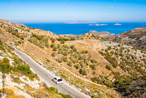 Obraz na płótnie Car driving on scenic mountain road leading to sea coast, Naxos island, Cyclades, Greece w salonie
