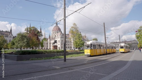 Hungarian Parliament and yellow tram on a sunny day, Budapest, Hungary