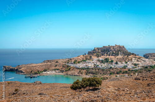 View of the bay, the town and the Acropolis of Lindos, in the island of Rhodes, in Greece.
