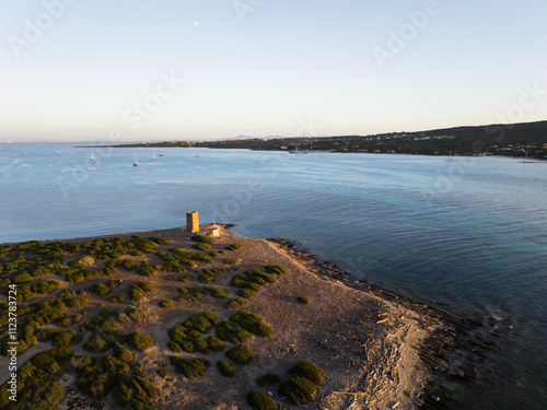 Aerial view of La Pelosa beach at sunset. Stunning light, white sand, and a paradisiacal landscape. photo