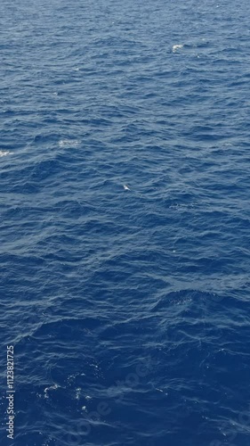 4K Ocean Surface Blue Sea Water Calm Vertical. Perfect social networks video format showing tranquil marine aqua ideal for stories and reels