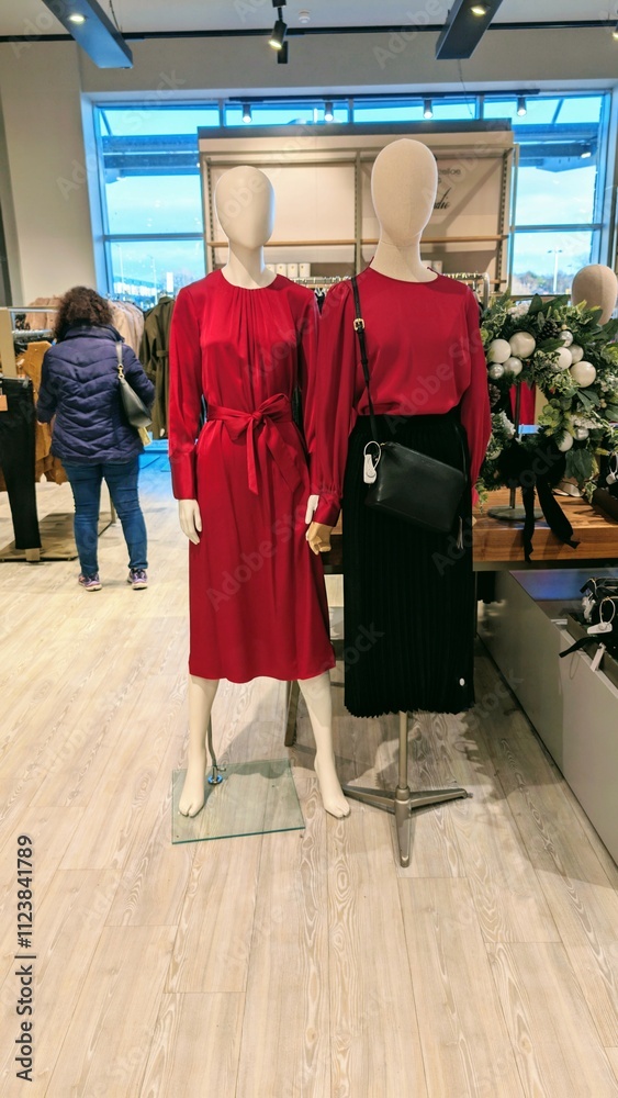 Plastic mannequin wearing colourful clothing style at Dunnes stores, fashion and clothing shop interior