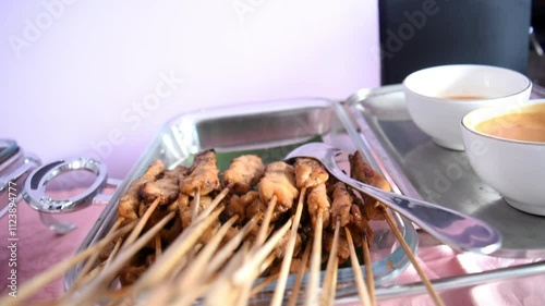 Chicken satay with peanut sauce served in a buffet lunch. Self-service catering menu for small parties. photo