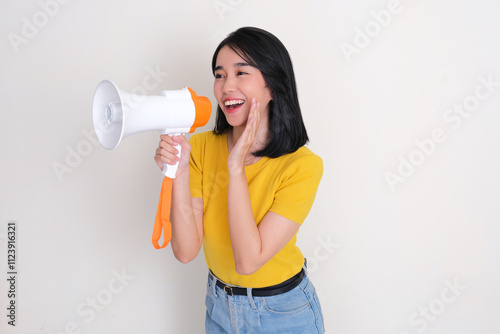 A woman telling something excited using megaphone photo