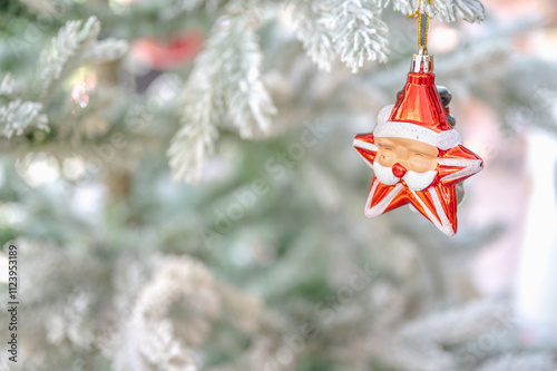 Christmas tree decorated with red and white stars and balls. Selective focus.