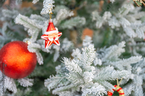 Christmas tree decorated with red and white stars and balls. Selective focus.